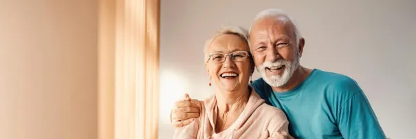 Elderly couple posing and smiling