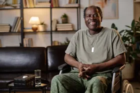 Disabled veteran in wheelchair at home.