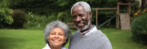 Elderly couple posing for photo outside