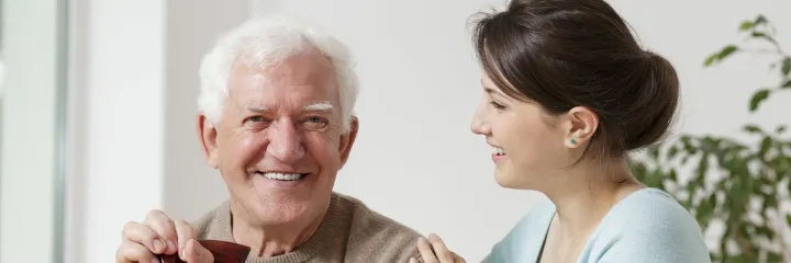 Senior and daughter smiling