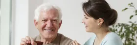 Senior and daughter smiling