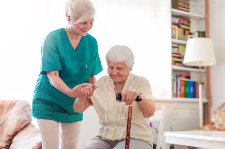 Caregiver helps older woman