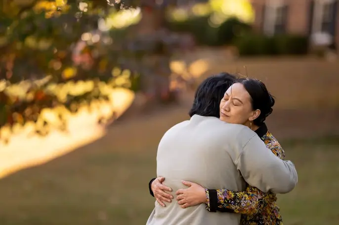 Family caregiver embraces an older loved one, representing the emotional impact of caregiving and caregiver burnout.