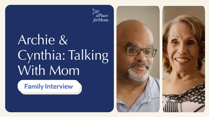 An elderly woman and adult son smiling during an interview