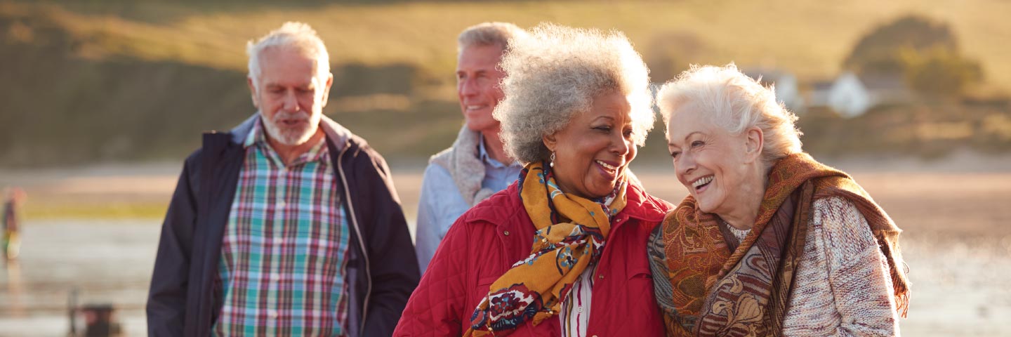 Two elderly couples walking outside