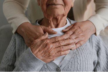 A caregiver reassures an older woman