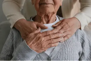 A caregiver reassures an older woman