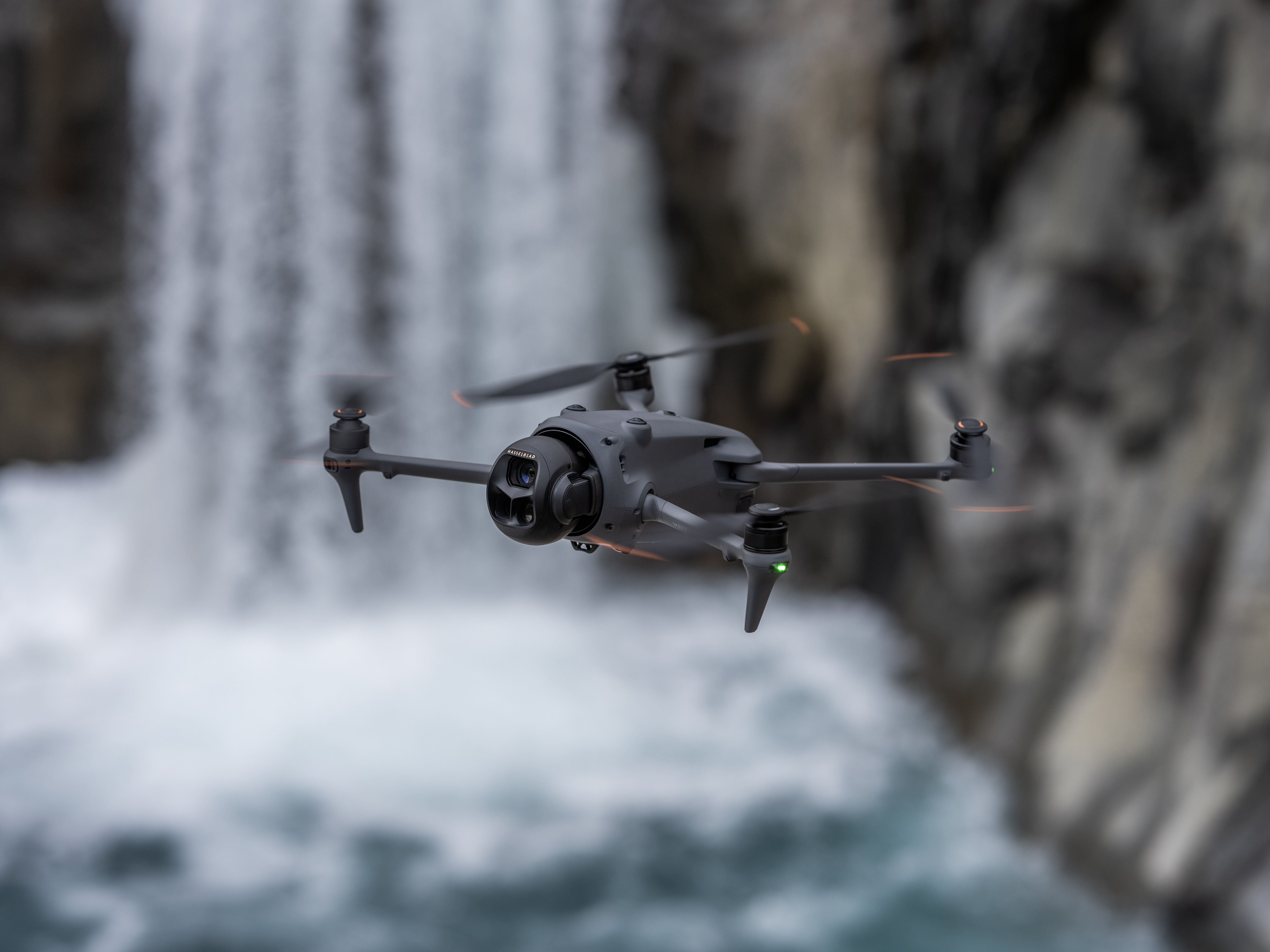 DJI Mavic 4 Pro in flight over a waterfall