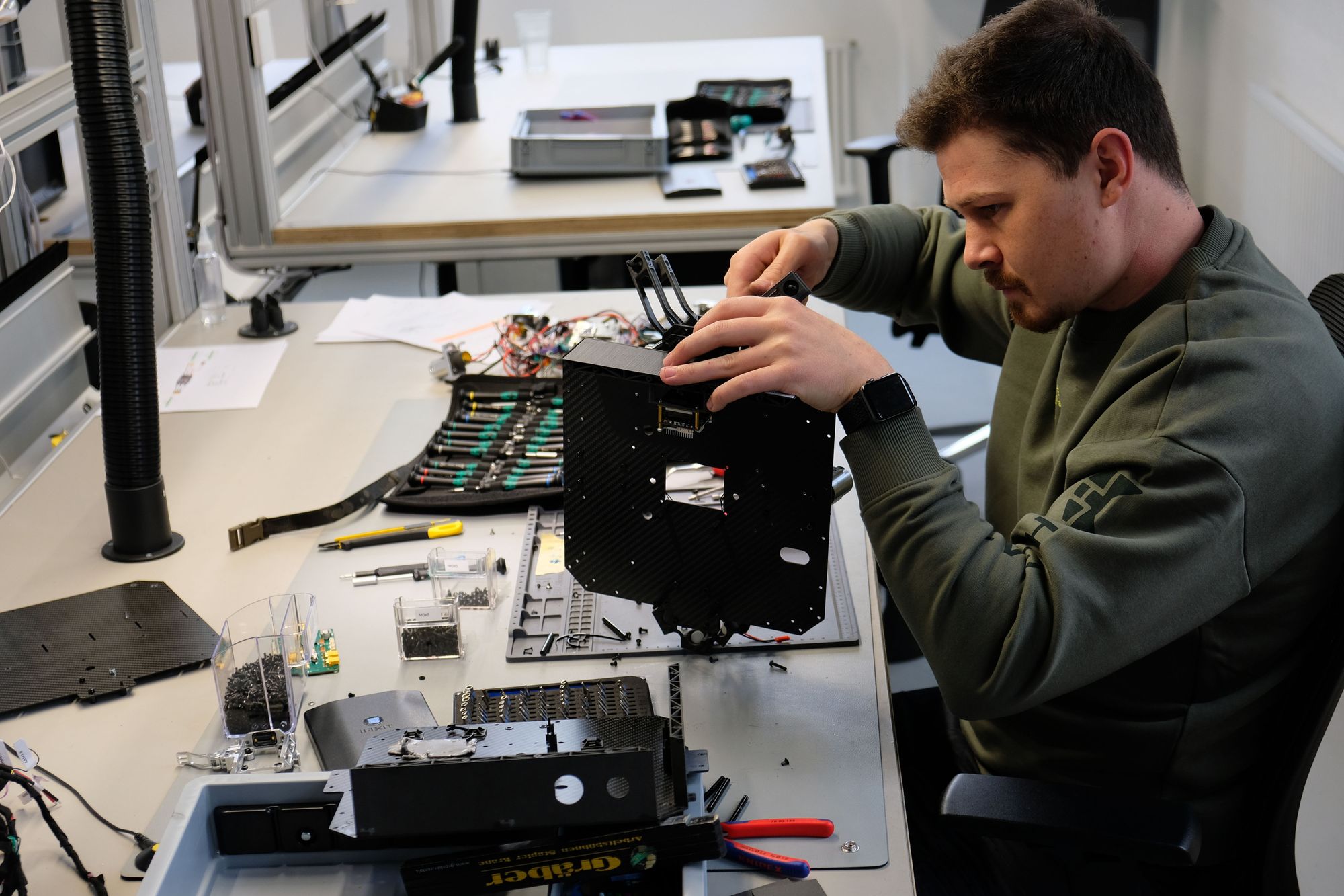 A Highcat engineer assembling a modular drone airframe in the workshop