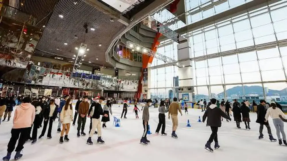 indoor ice skating rink floor to ceiling windows harbour view Hong Kong