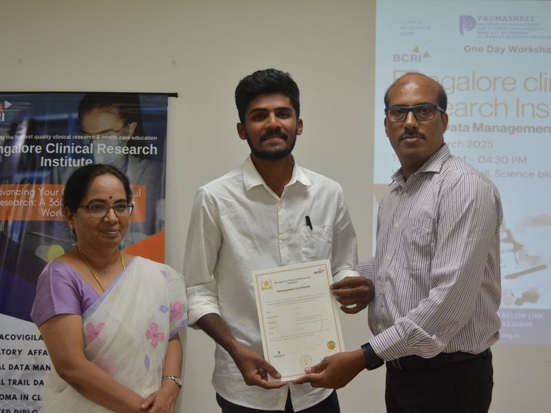 Student receiving a certificate from BCRI representatives during a certificate ceremony.