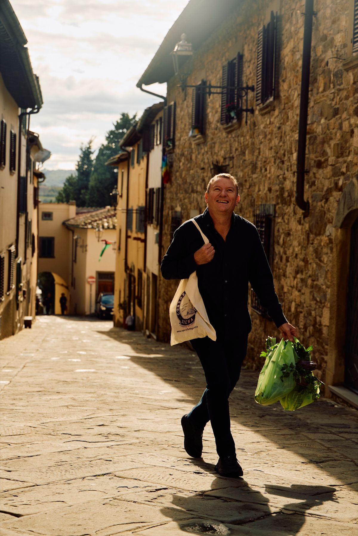 Theo Randall sitting outside Osteria il Grattacielo in Tuscany during the cookbook shoot.