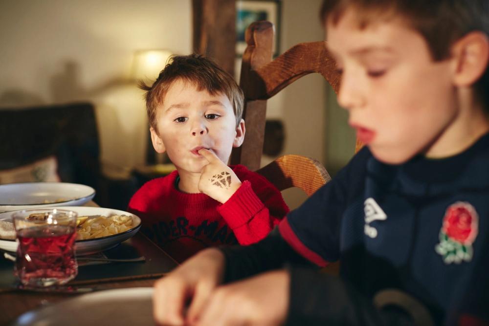 Child Eating Crisps Family Kitchen