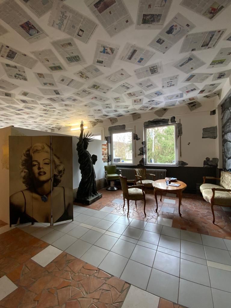a room with a large painting on the ceiling