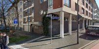 a person walking down the street in front of a building