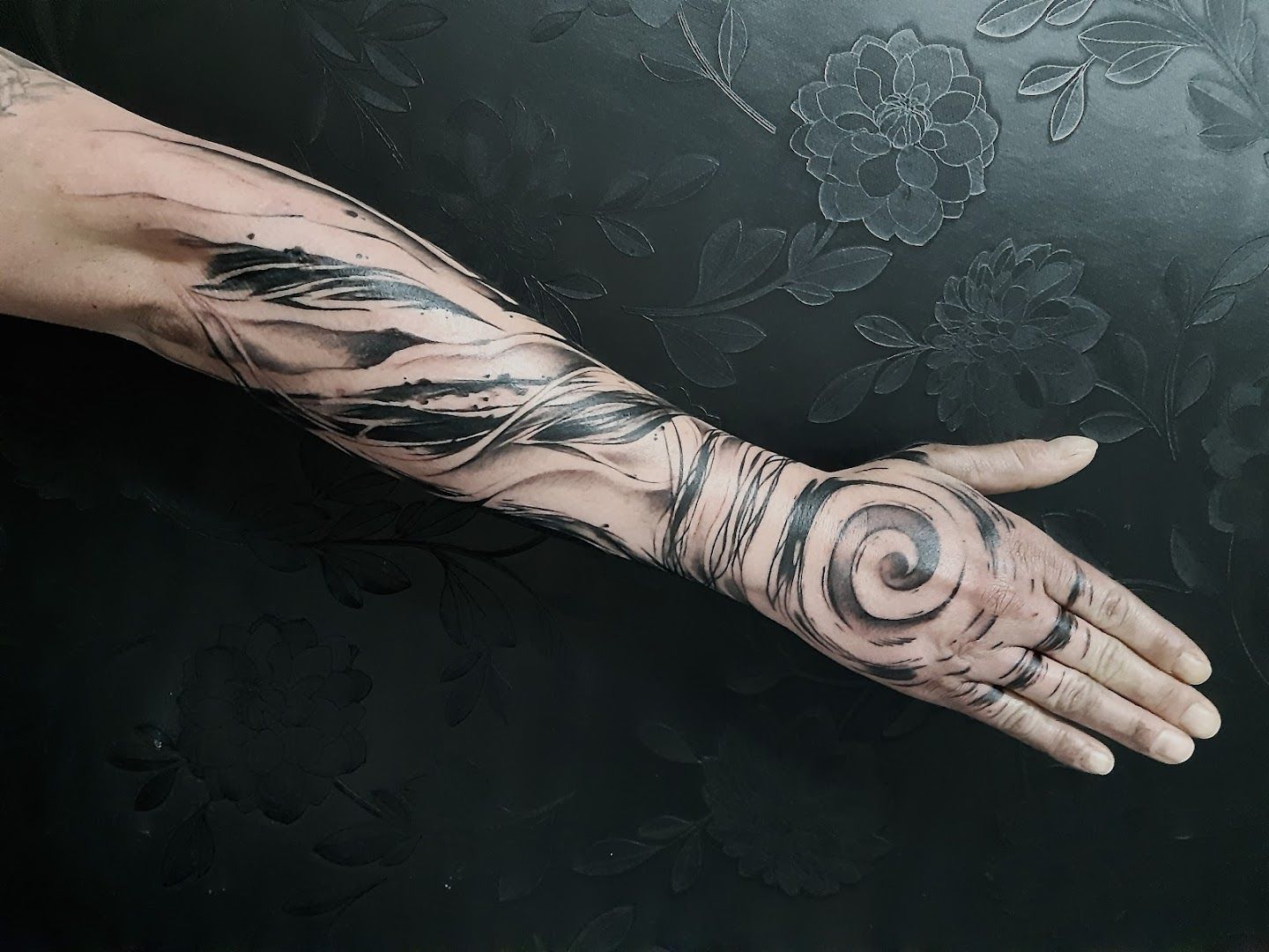 a hand with a black and white cover-up tattoo design, aichach-friedberg, germany