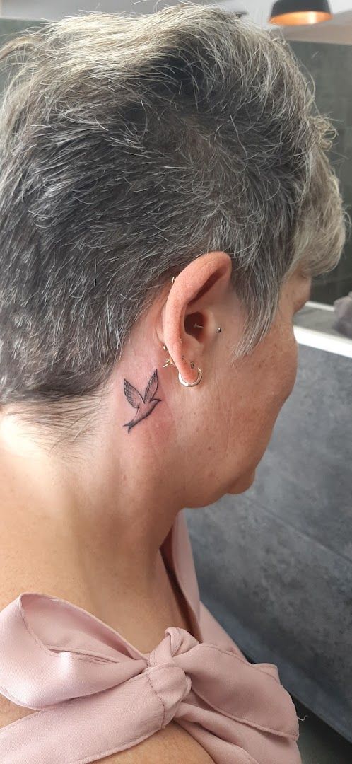 a woman with a small narben tattoo on her neck, merzig-wadern, germany