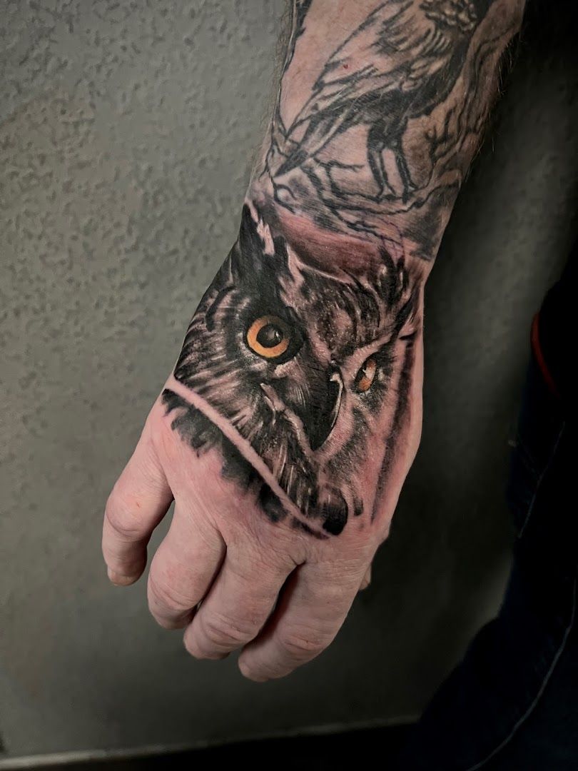 a man's hand with an owl cover-up tattoo on it, karlsruhe, germany