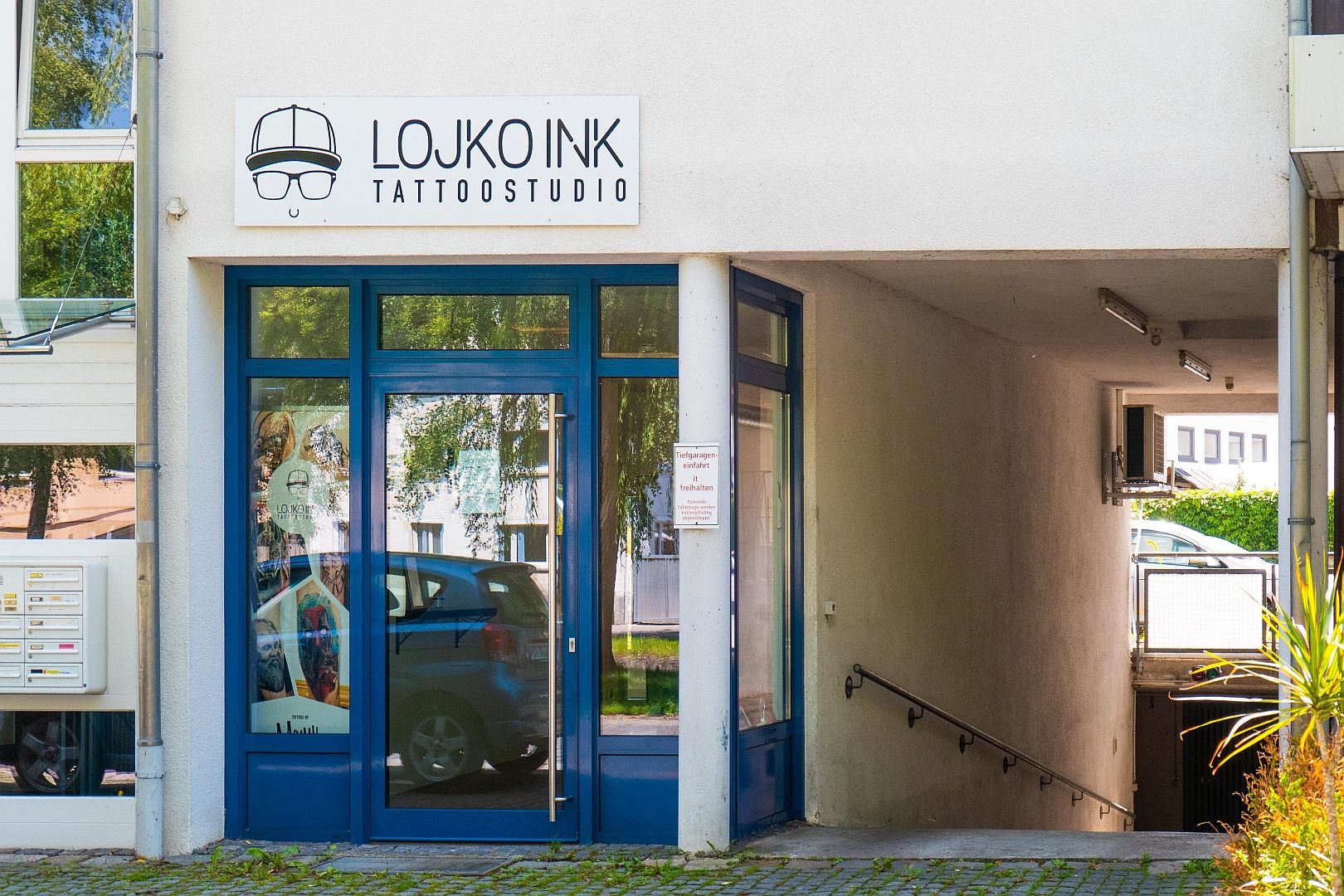 a blue door is open in front of a building
