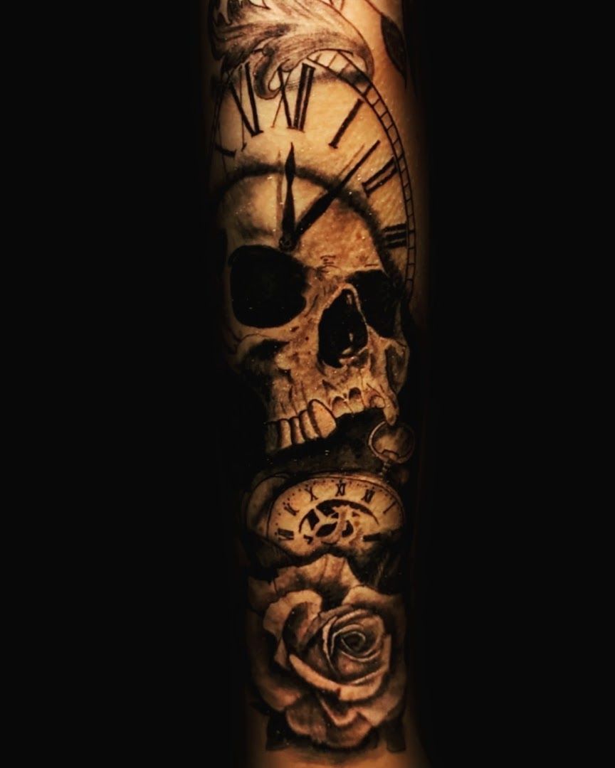 a skull with a clock and roses on it