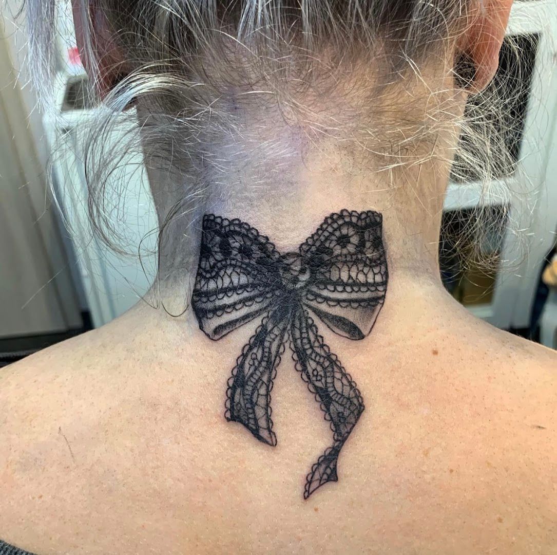 a woman with a black bow blackwork tattoo on her neck, mansfeld-südharz, germany