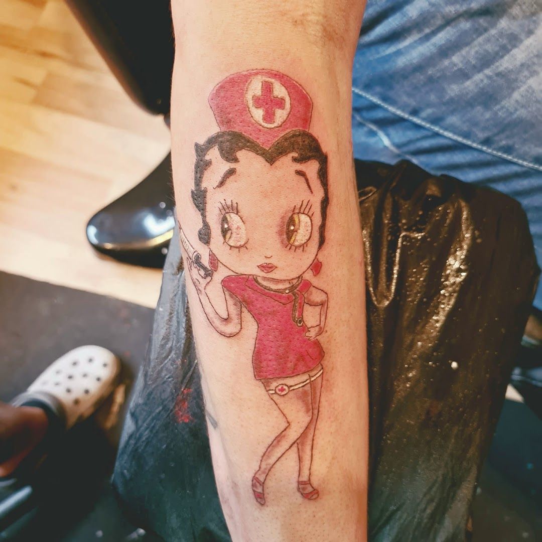 a narben tattoo of a girl with a sailor hat on her arm, ammerland, germany