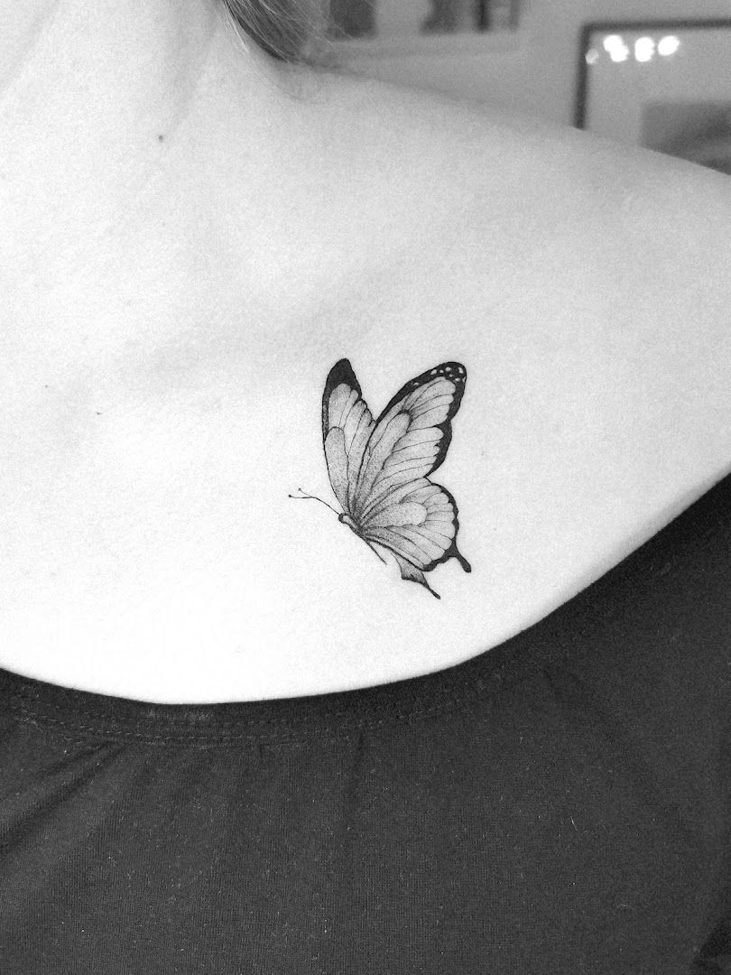 a woman with a butterfly narben tattoo on her shoulder, breisgau-hochschwarzwald, germany