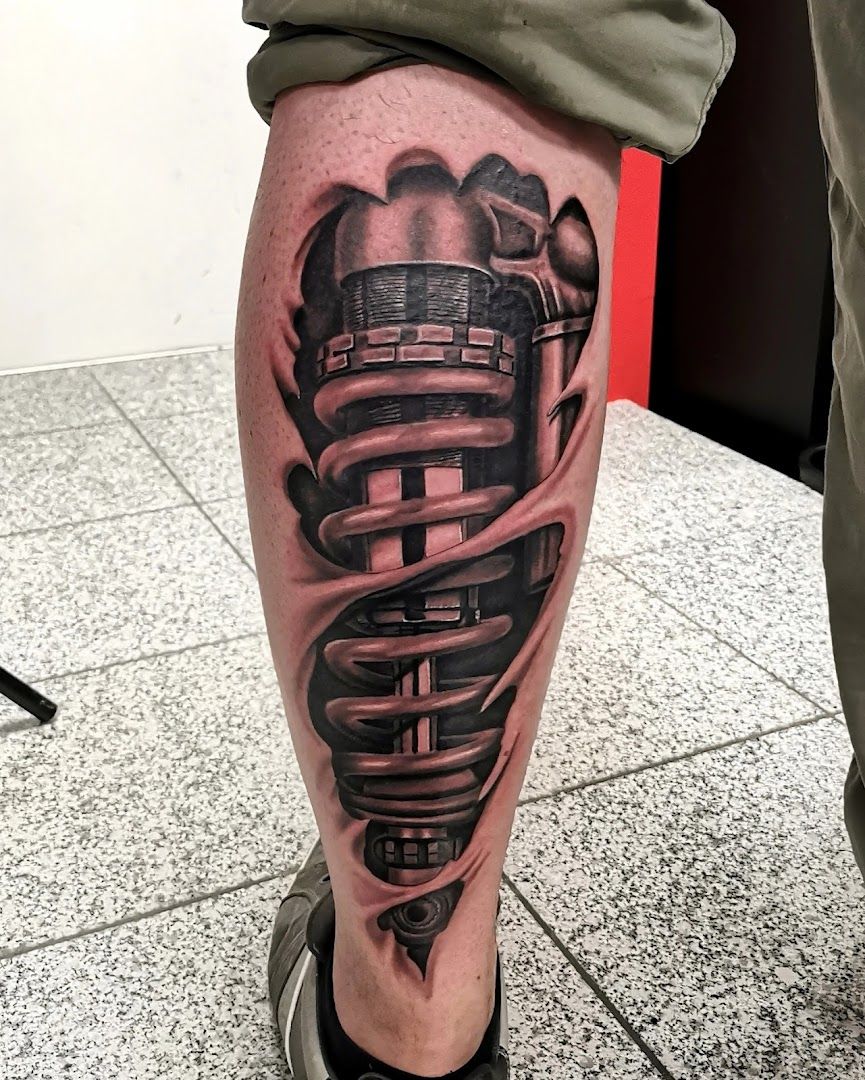 a man's leg with a black and grey cover-up tattoo of a car, nürnberg, germany