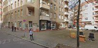 a street with buildings and people walking on it