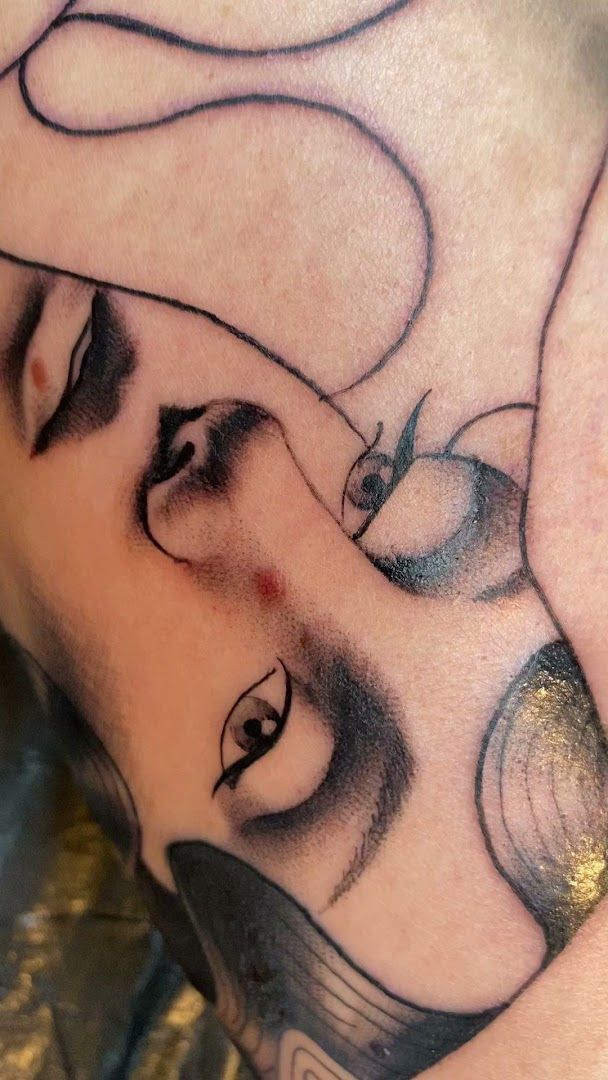 a narben tattoo of a woman's face with a black and white ink, duisburg, germany