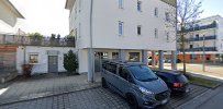 a street with cars parked in front of a building