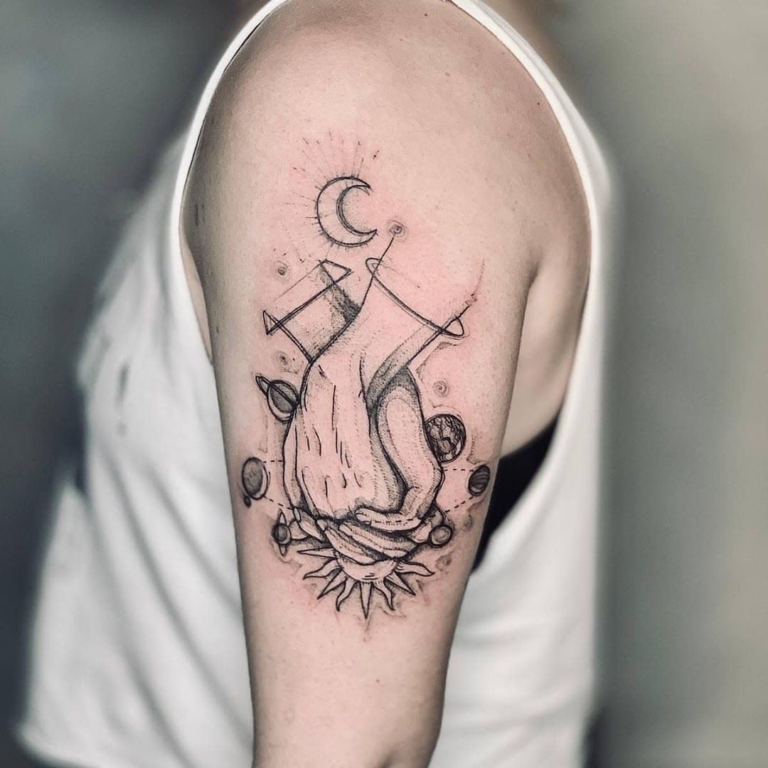 a man's arm with a narben tattoo of a cat and a moon, bonn, germany