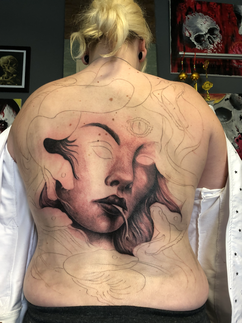 a woman with a cover-up tattoo on her back, neu-ulm, germany