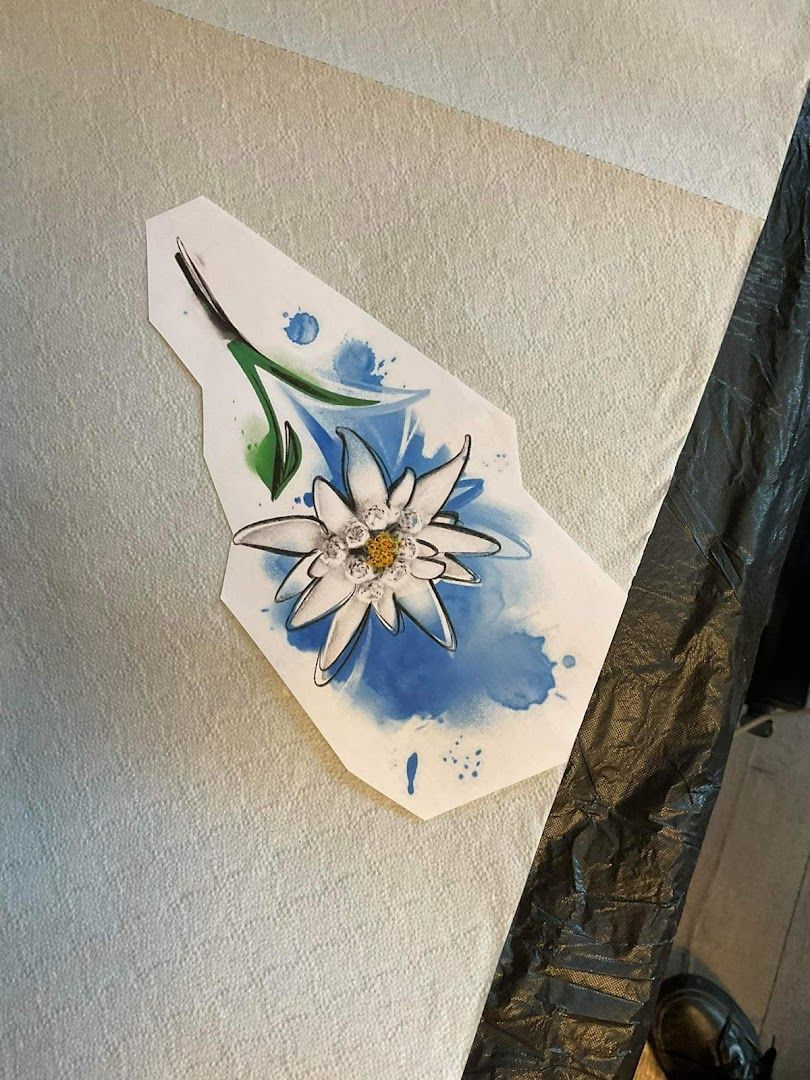 a piece of paper with a flower painted on it