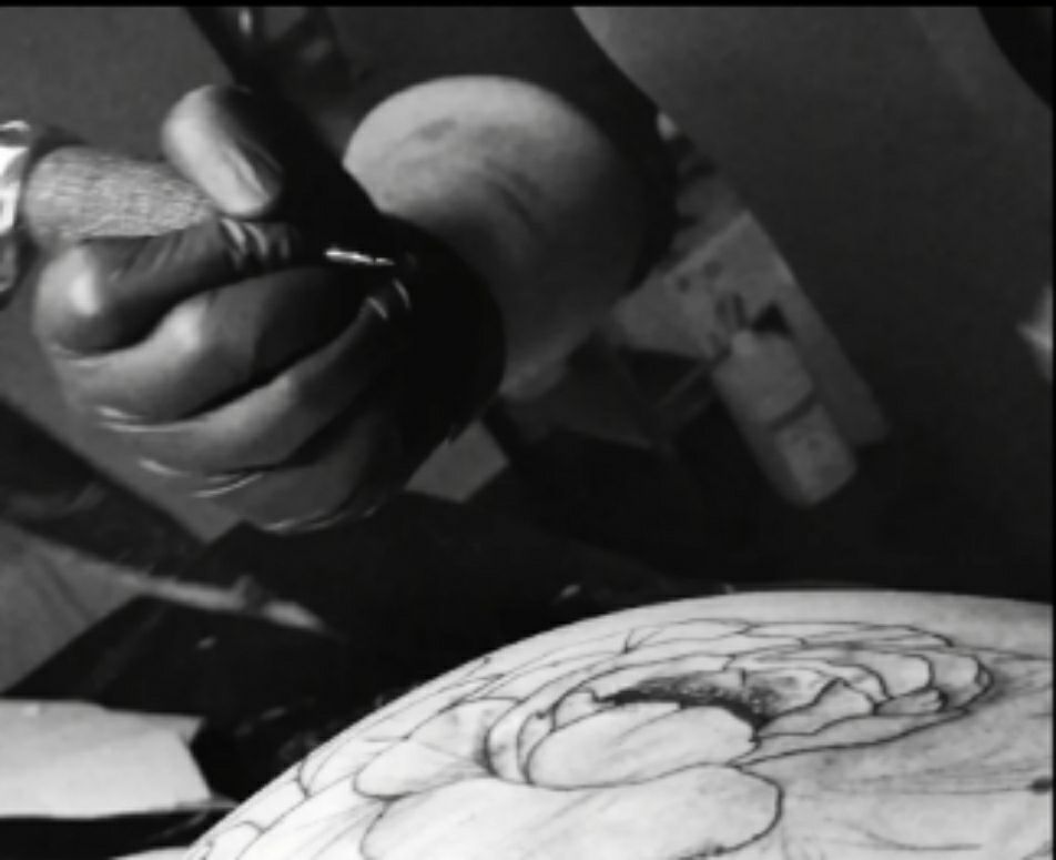 a man is working on a piece of art