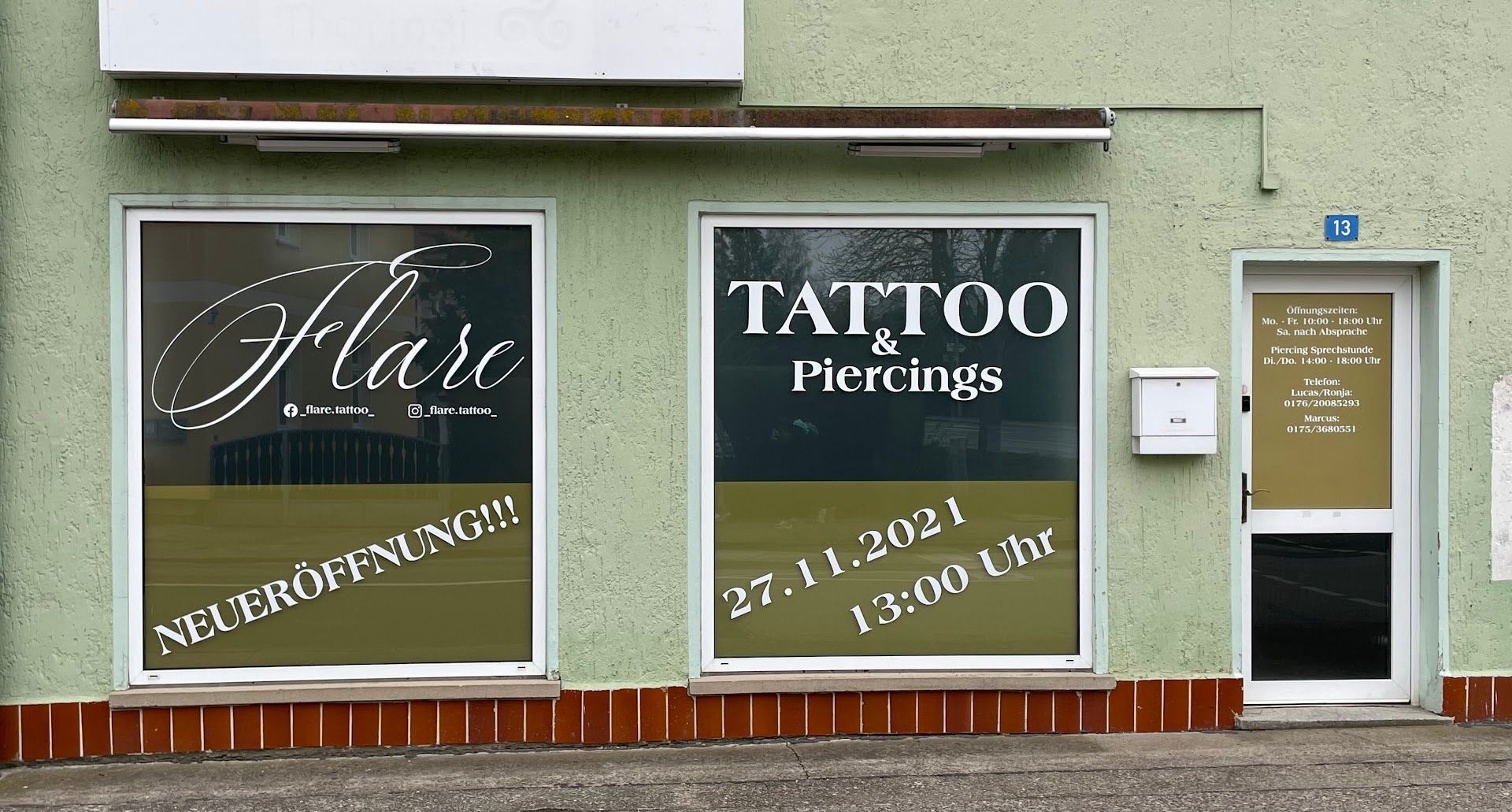 a storefront with two windows and a sign that says ta
