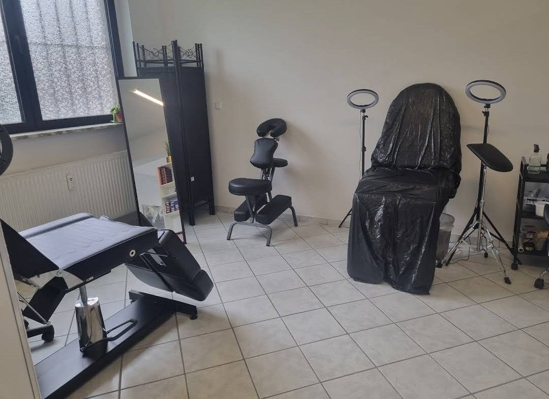 a salon room with a chair and a mirror