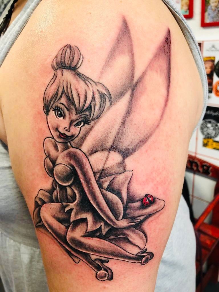 a cover-up tattoo of a little fairy sitting on a flower, schwerin, germany