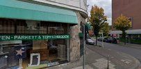 a street view of a building with a green aw