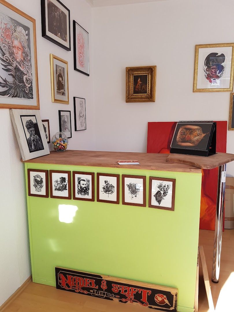 a green counter with pictures on the wall