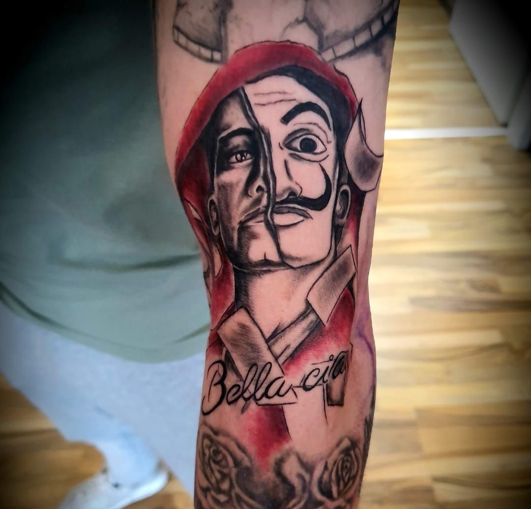 a cover-up tattoo of a man with a red hoodie and a black and white face, kleve, germany