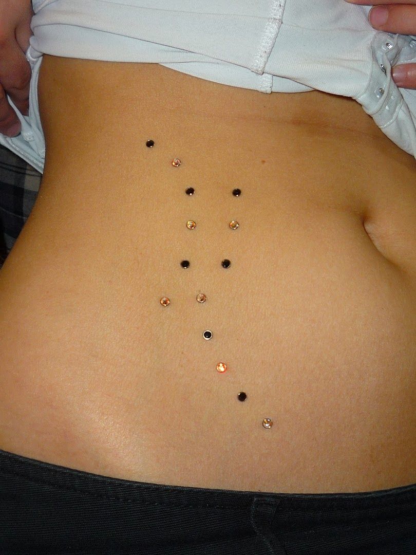 a woman's stomach with a small amount of black stones