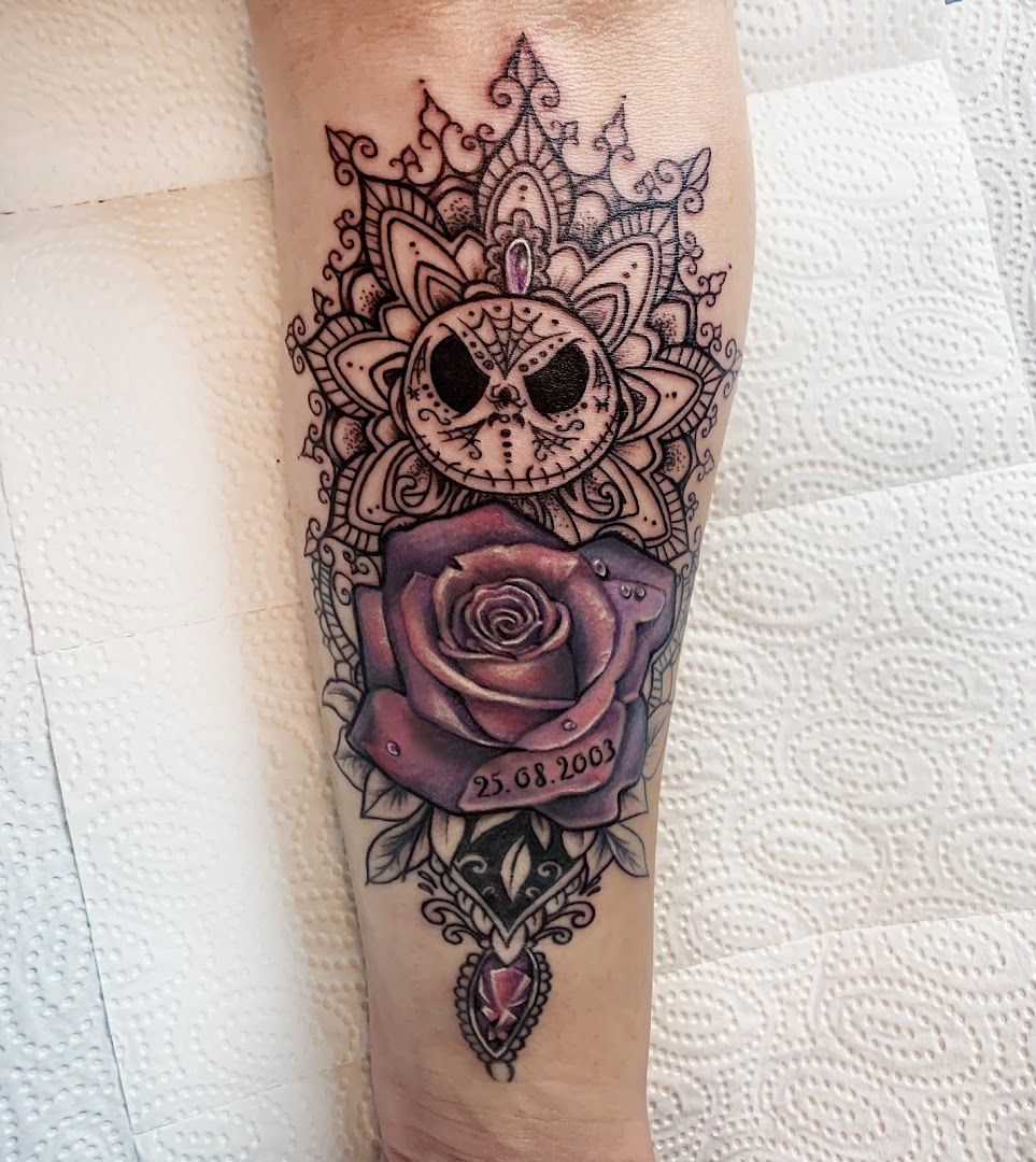 a cover-up tattoo with a skull and rose on the forearm, berlin, germany