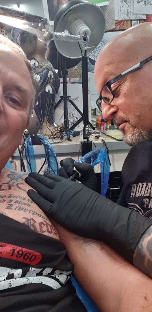 a man getting his arm narben tattooed by a tattoo artist, berlin, germany