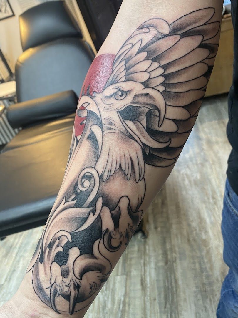 a narben tattoo of an eagle with a red ball on its head, duisburg, germany