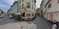 a street with buildings and people walking down it