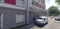 a street view of a building with cars parked in front