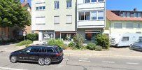 a street with cars parked in front of a building