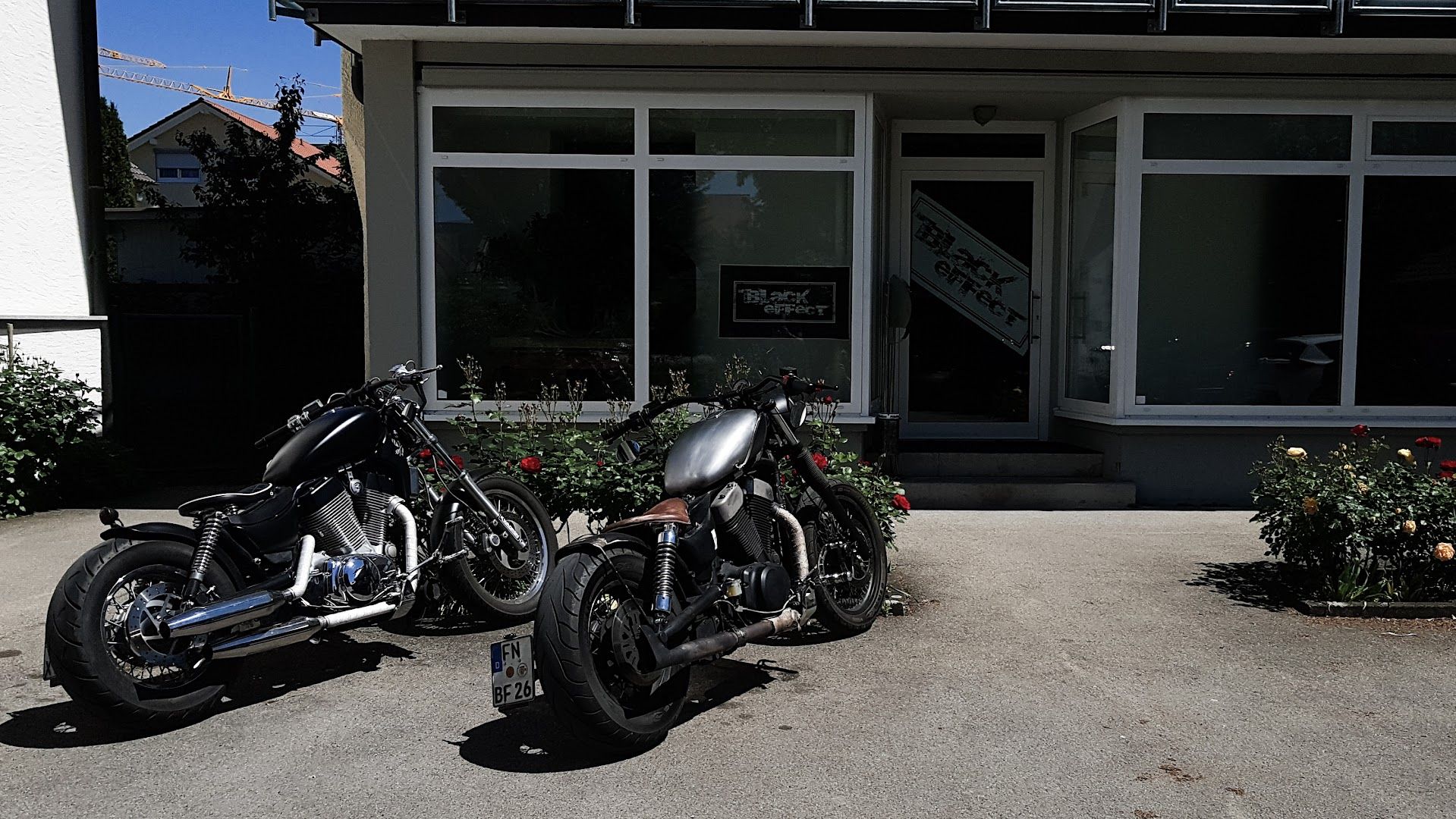 two motorcycles parked in front of a building