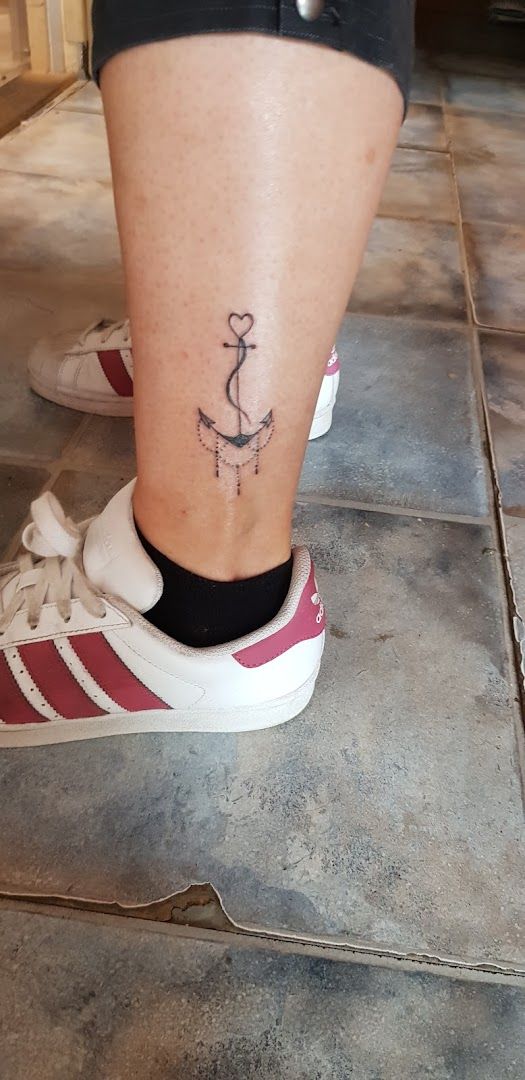 a woman's foot with a small anchor narben tattoo on it, oder-spree, germany